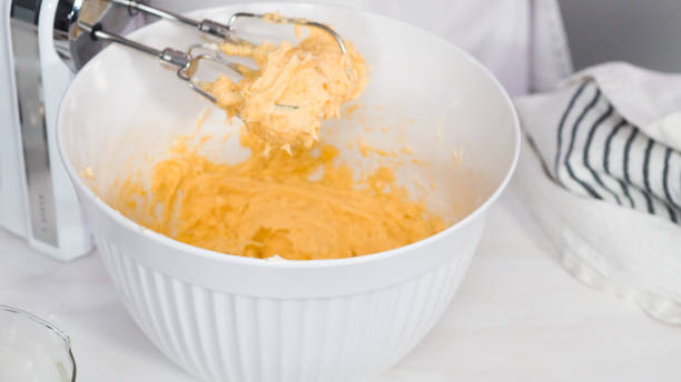 istock Mixing batter to bake vanilla cupcakes 1154080688