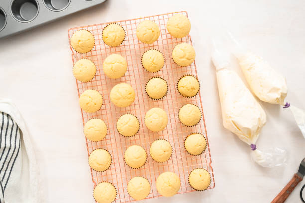 istock Decorating vanilla cupcakes with a white buttercream icing 1154080748