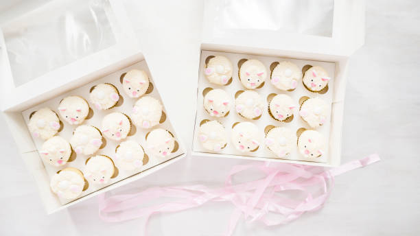 istock Boxing vanilla cupcakes in shape of Easter bunnies. 1154080825