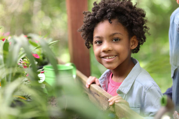 istock Cute little girl gardening outdoors in spring. 1154081783