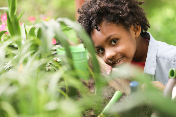 istock Cute little girl gardening outdoors in spring. 1154081790