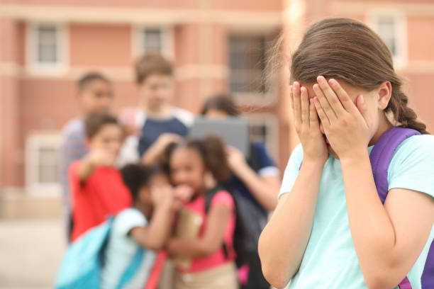 istock Elementary age girl being bullied at school. 1154083051