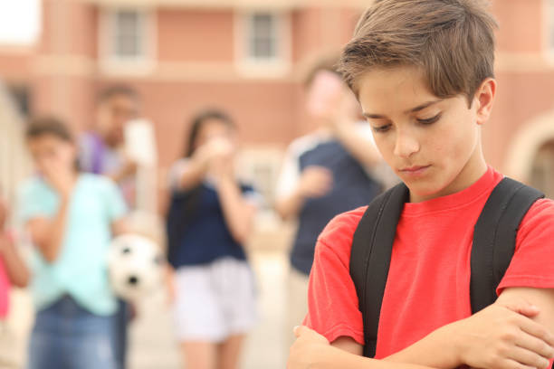 istock Elementary age boy being bullied at school. 1154083069