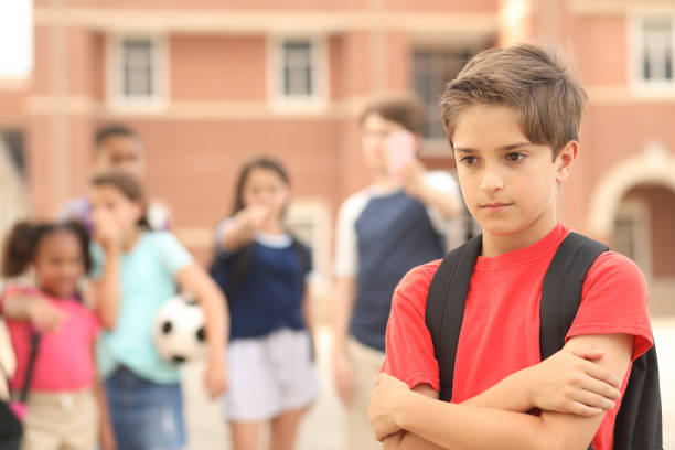 istock Elementary age boy being bullied at school. 1154083102