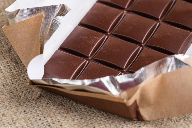 istock Close-up part of chocolate in opened wrapper on burlap. 1154083162