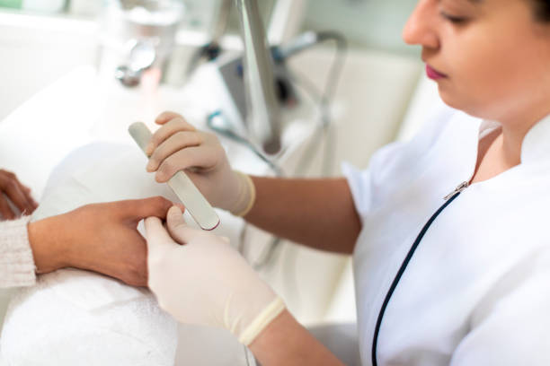 istock Using a nail file to do manicure in a cosmetic center 1154083399