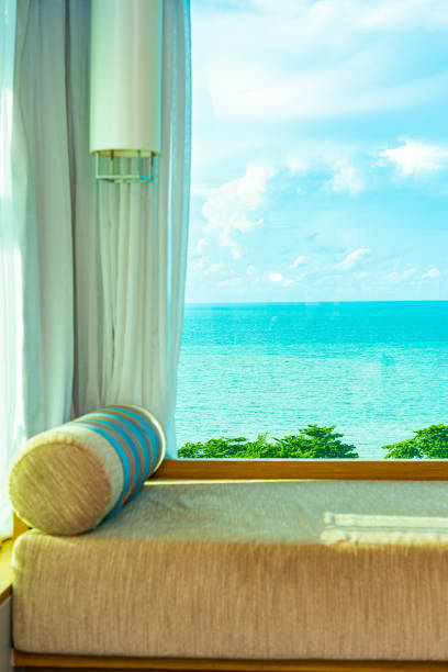 istock Beautiful comfortable pillow on sofa with sea ocean white cloud on blue sky view 1154083589