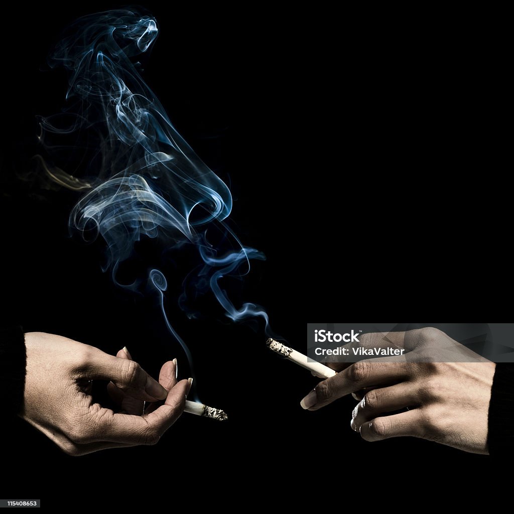 two smokers two hands having a conversation while holdinga  cigarette Addiction Stock Photo