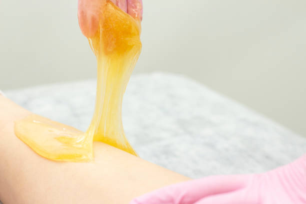 istock sugar depilation cosmetic procedure applying shugaring paste on skin 1154088098