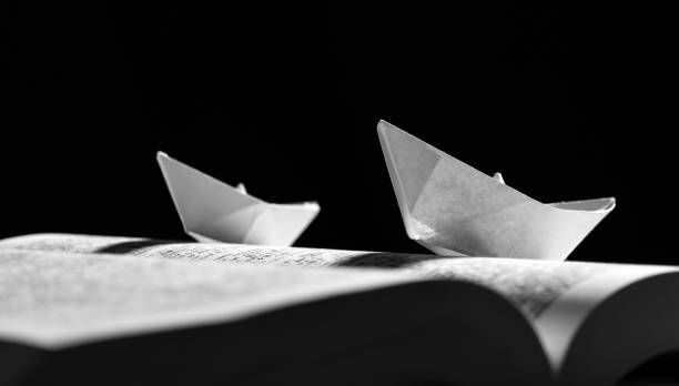 istock Paper boats on the opened book 1154090309