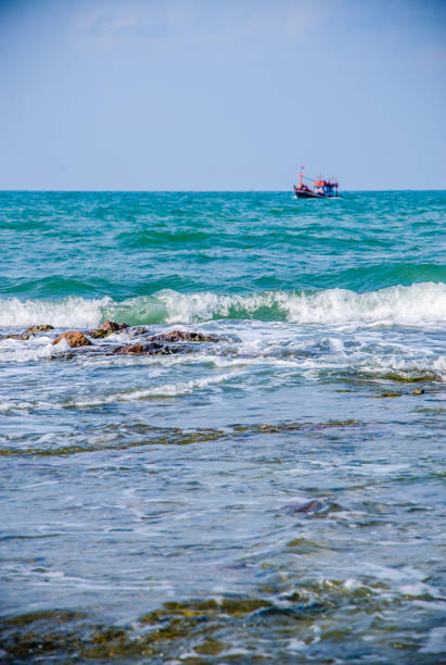 istock Ocean waves breaking on the rocks on the shore. 1154096311