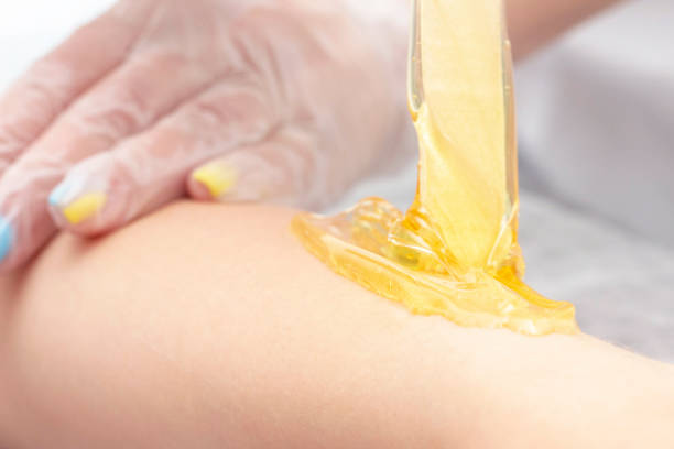 istock sugar depilation cosmetic procedure applying shugaring paste on skin 1154098347