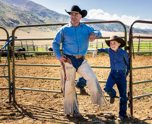 istock Father and son taking a break on the ranch 1154098368