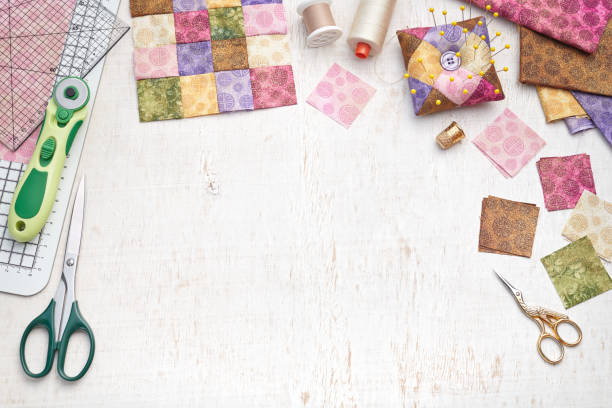istock Bright square pieces of fabric, patchwork tools, sewing equipment, traditional quilting, space for text 1154100499