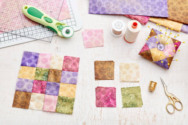 istock Bright square pieces of fabric, patchwork tools, sewing equipment, traditional quilting 1154100500