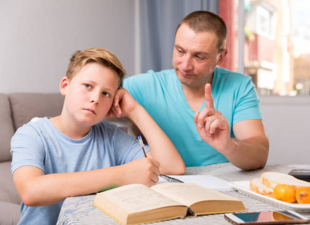 istock Adult son is not wanting talk with his father in time doing homework 1154100817