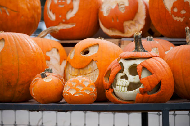 Artistically carved pumpkins on display form one of the main attractions for busloads of tourists drawn to experience the annual Halloween decorations at the 300-acres family farm and orchard in Media, Delaware County, Pennsylvania.