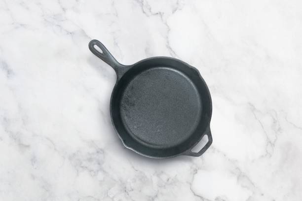 istock Cast iron frying pan on a marble background 1154104770
