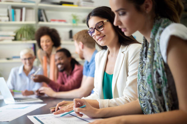 istock Team of colleagues brainstorming together while working in modern office 1154104919