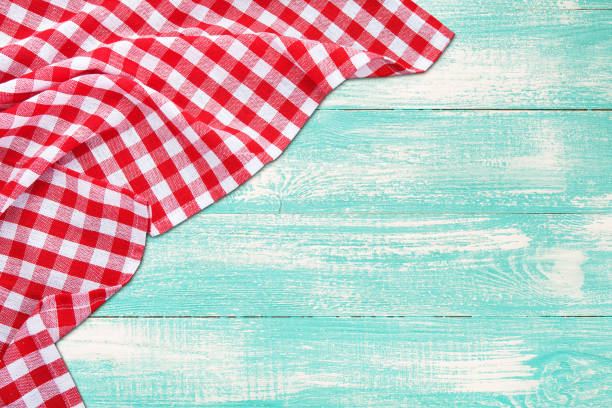 istock Vintage wooden table with red checkered tablecloth. Top view mockup. 1154104999