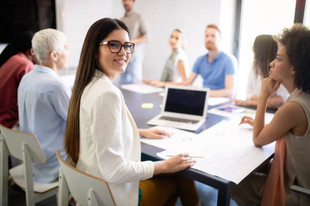 istock Group of successful business people at work in office 1154105063