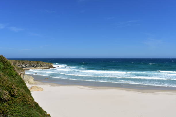 istock Beach with white sand, rocks and waves. View from a cliff, Lugo, Spain. 1154105192