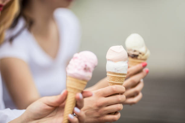 istock Delicious three ice cream in female hands - close-up. 1154105232