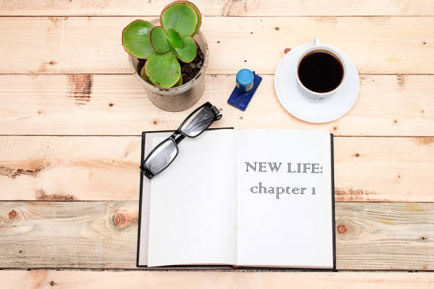 istock New life: chapter 1 on open book on wooden table 1154107108