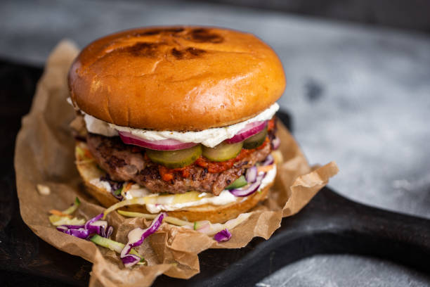 istock Close up fresh burger on wooden table. 1154107687