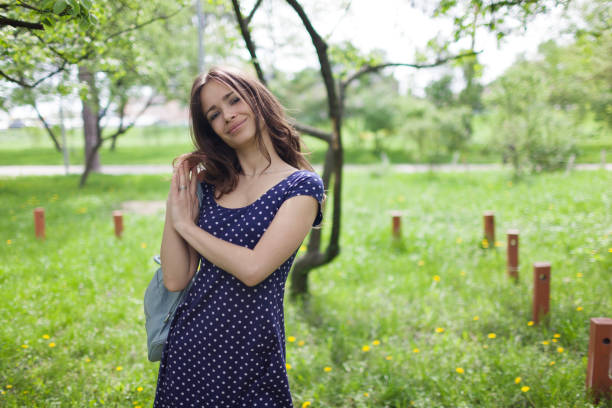 istock Young happy woman smiling enjoying spring day 1154108762