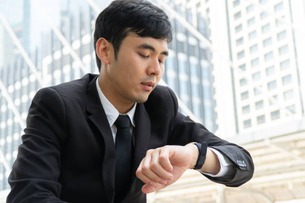 istock Business man watching on wristwatch. 1154109045