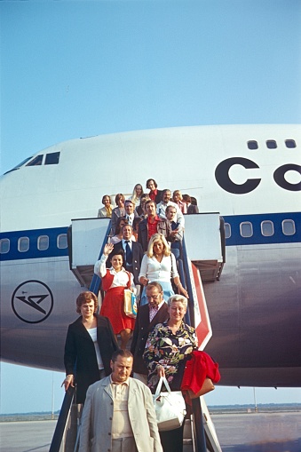 Malaga, Andalusia, Spain, 1975. Flight passengers leave via a gangway a Boeing 747 at the destination in Spain.