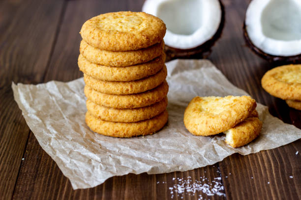 Coconut cookies on a brown wooden background. Coconuts.