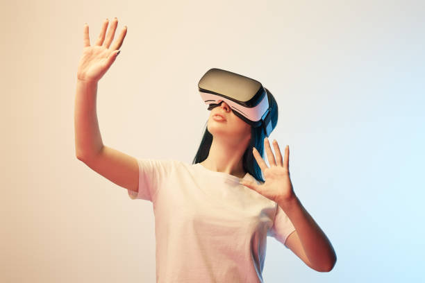 istock young woman in virtual reality headset gesturing on beige and blue 1154111979
