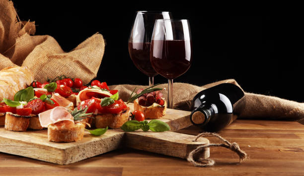 istock antipasto various appetizer. Cutting board with prosciutto, salami, cheese, bread and olives on dark wooden background 1154114915