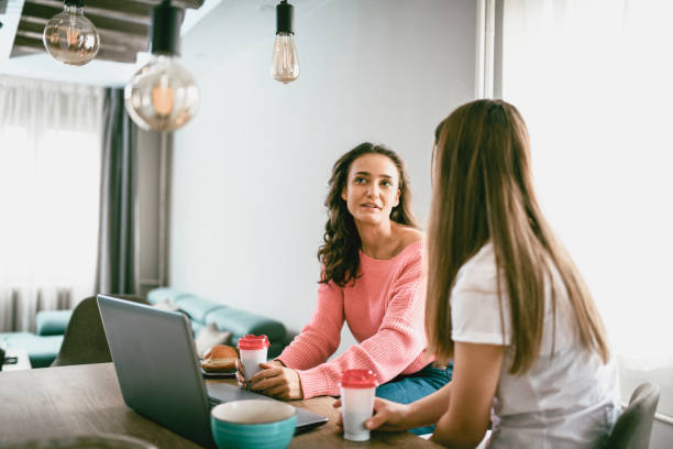 istock Female Friends Gossiping Over Coffee 1154115131