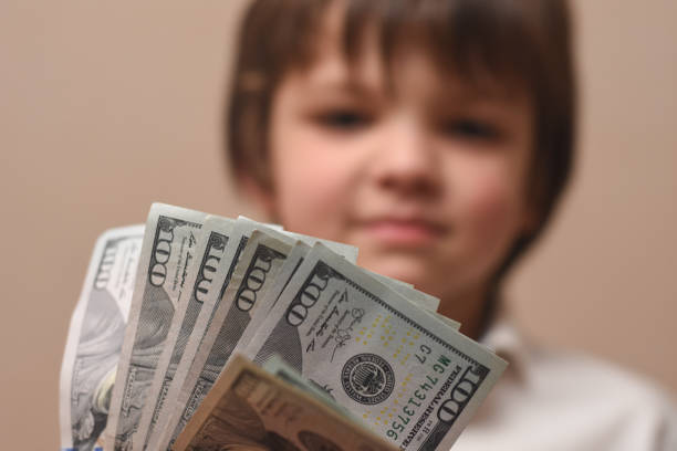 istock Money in a Child hand close up 1154117576