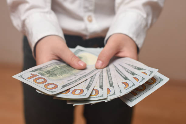 istock Money in a Child hand close up 1154117763