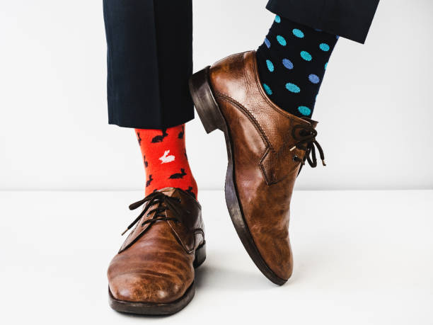 istock Office Manager in stylish shoes and bright socks 1154121019