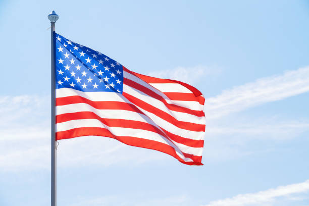 american flag against blue sky - star shape striped american flag american culture imagens e fotografias de stock