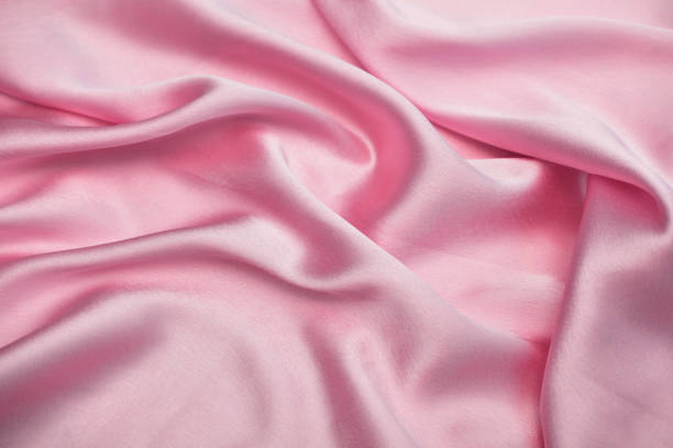 istock silk texture background, baby pink satin cloth abstract background 1154125177