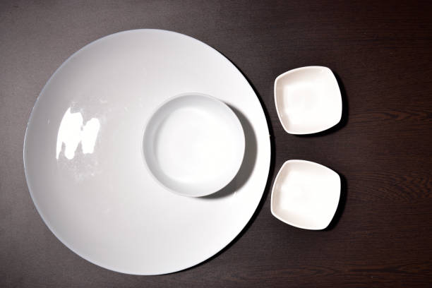 istock top view on wooden table of empty plate, bowl. 1154125191