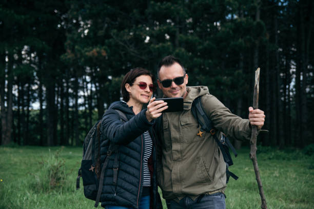 istock Happy hikers on a mountain trail 1154125368