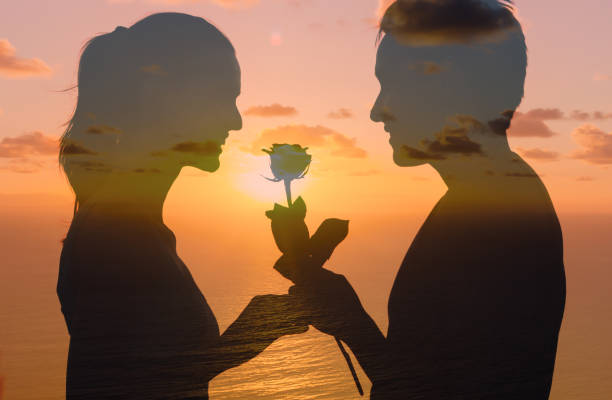 istock Man giving woman a rose. 1154126994