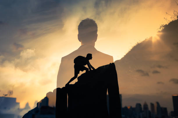 People never giving up Man feeling determined climbing up a steep mountain side. simile pic stock pictures, royalty-free photos & images