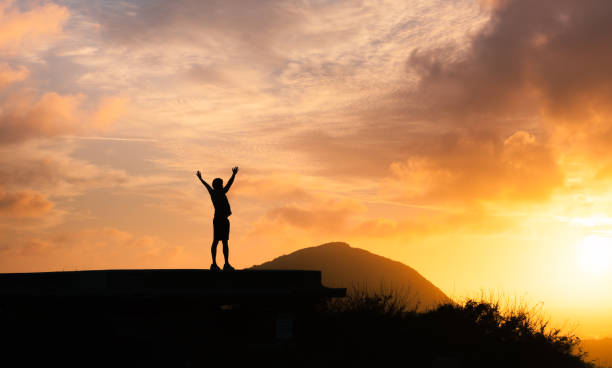 istock Man hiker celebrating his successful climb 1154127152