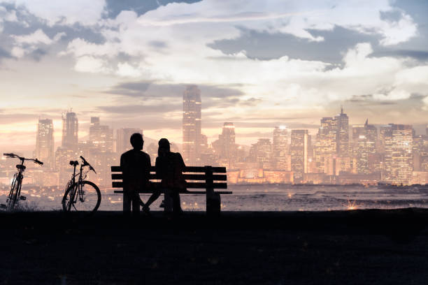 istock Couple relaxing on bench in the city 1154127157