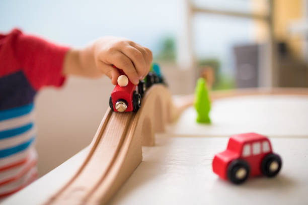 istock Cute little boy playing with toy train 1154127377