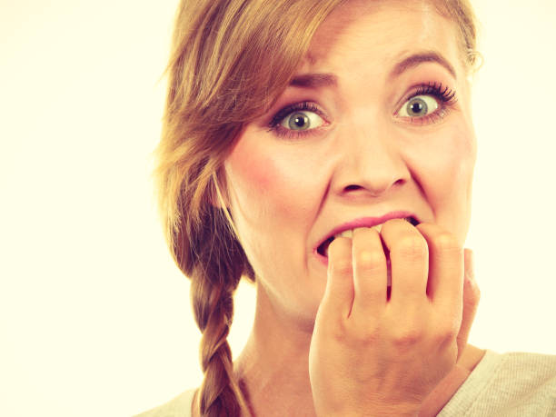 istock Scared, stressed woman biting her nails 1154129273