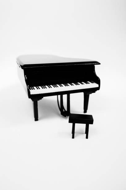 istock miniature classic piano keyboard instruments isolated on white background. selective focus 1154129863